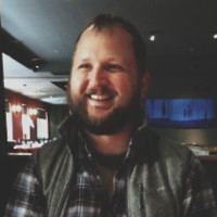 Profile Picture of Adam w Freeman, bearded and bespectacled.